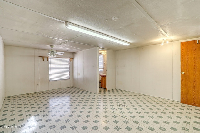 empty room with tile patterned floors and ceiling fan