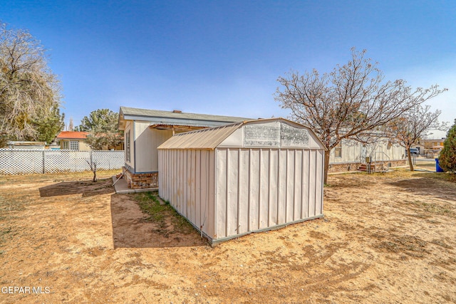 view of shed featuring fence