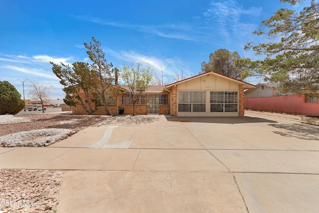 single story home with brick siding and driveway