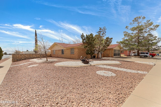 ranch-style home featuring brick siding