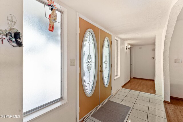 tiled foyer with baseboards