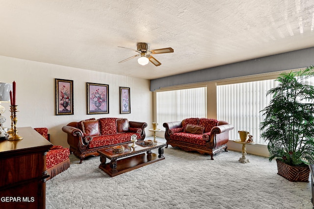 carpeted living area featuring plenty of natural light, a textured ceiling, and a ceiling fan