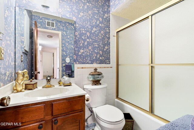 full bathroom with a wainscoted wall, toilet, and wallpapered walls