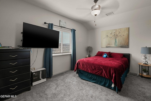 bedroom with visible vents, baseboards, carpet flooring, and vaulted ceiling