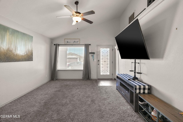 carpeted living area with vaulted ceiling and a ceiling fan