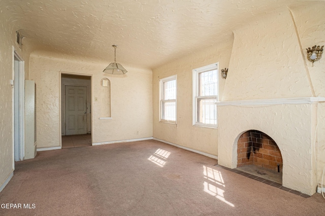 unfurnished living room with a premium fireplace, carpet flooring, a textured ceiling, and a textured wall