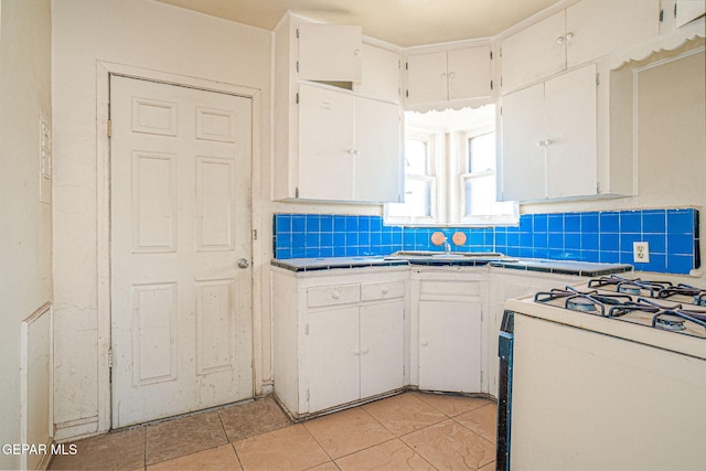 kitchen with white cabinetry and tasteful backsplash