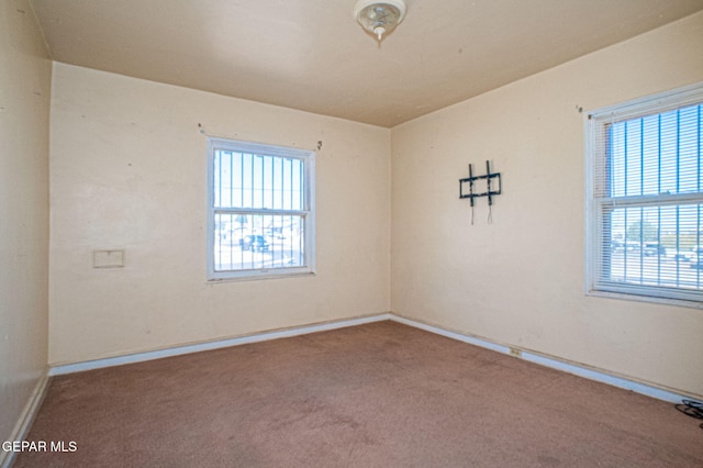 carpeted spare room with baseboards