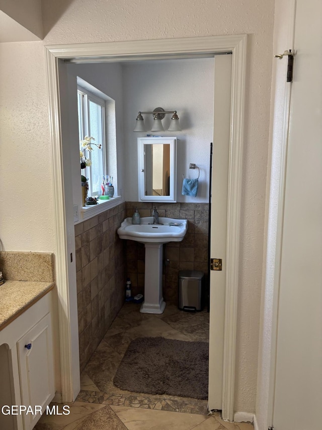 bathroom with tile walls