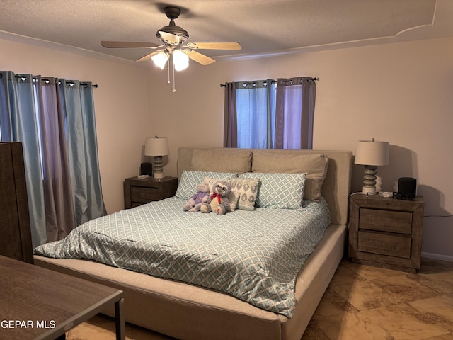 bedroom featuring a textured ceiling and ceiling fan