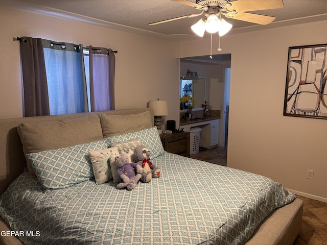 bedroom with baseboards, a textured ceiling, and ceiling fan