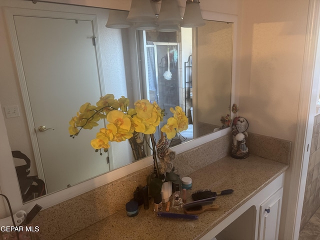 bathroom with a shower stall and vanity