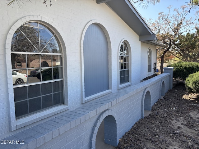 view of side of home with brick siding