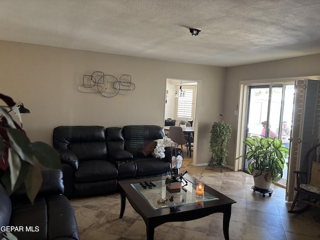 living area with baseboards and a textured ceiling