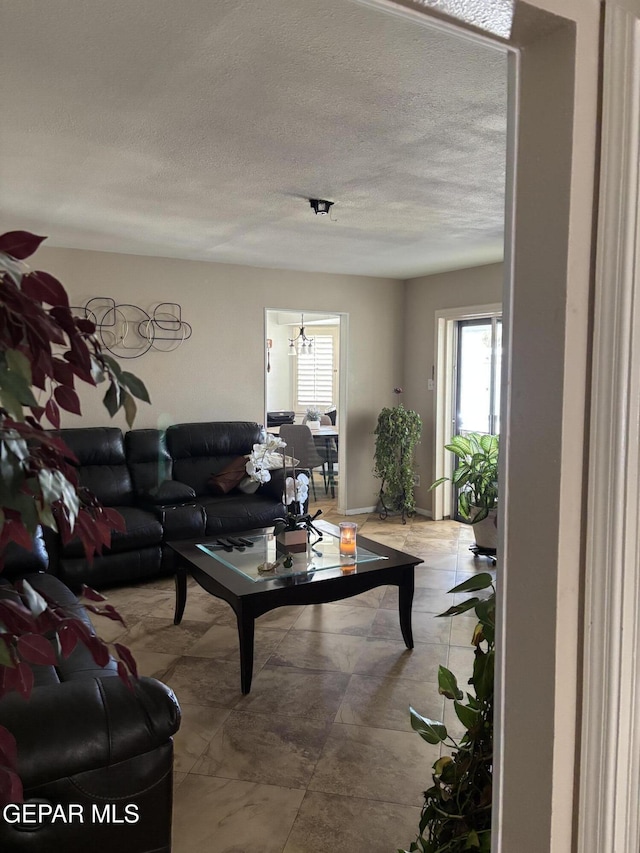 living area featuring plenty of natural light and a textured ceiling