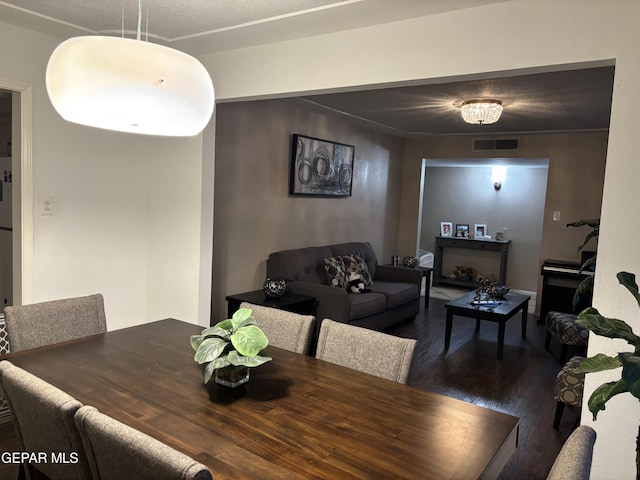 dining space featuring wood finished floors and visible vents