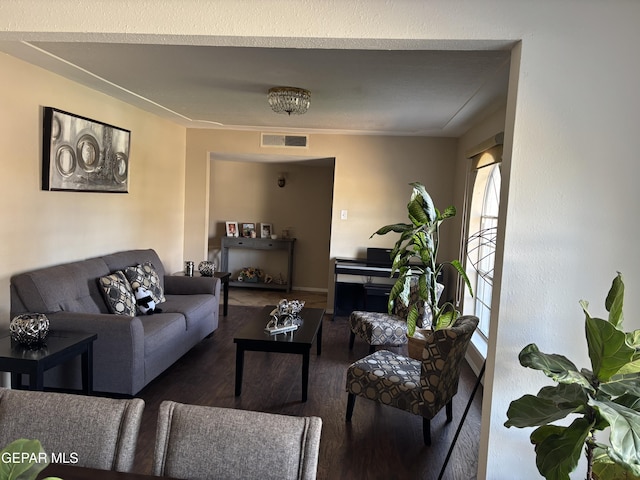 living room featuring visible vents and wood finished floors