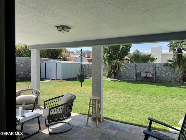 6908 Oveja Ave, El Paso, TX 79912 - view of yard with a patio, a storage unit, a fenced backyard, and an outdoor structure