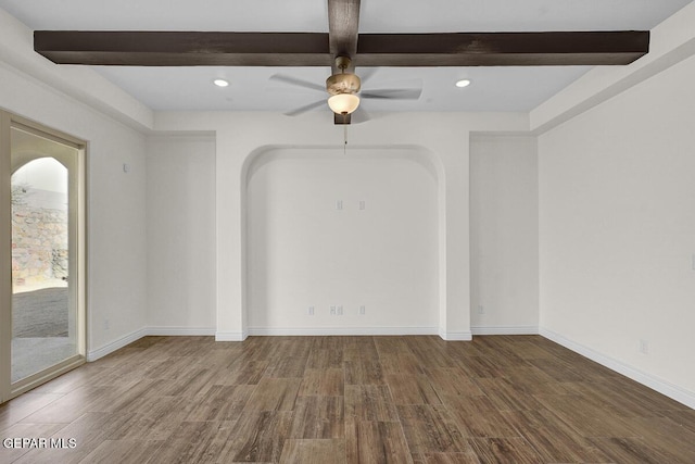 unfurnished room featuring wood finished floors, baseboards, beam ceiling, recessed lighting, and arched walkways