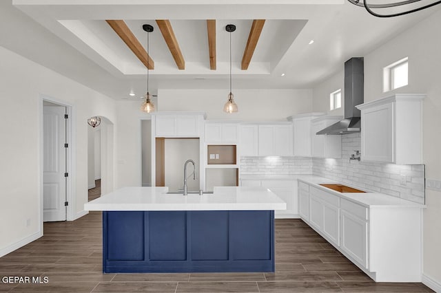 kitchen with decorative backsplash, black electric stovetop, wood tiled floor, and wall chimney range hood