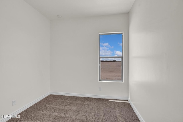 spare room with carpet flooring and baseboards