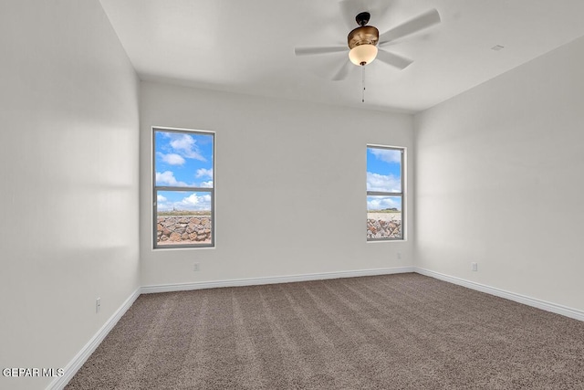 empty room with a ceiling fan, carpet, and baseboards