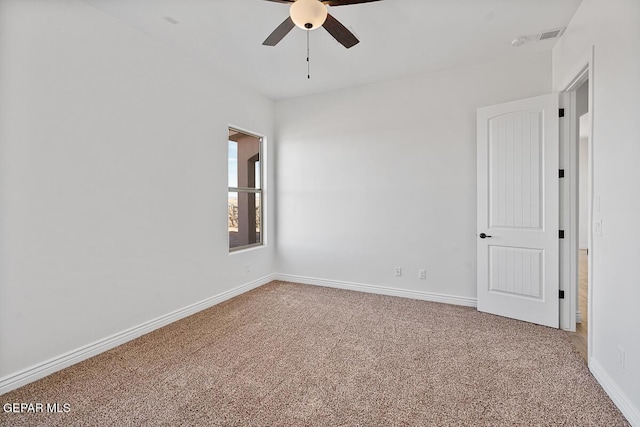 spare room with baseboards, carpet, and ceiling fan