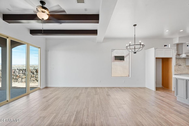 unfurnished living room featuring ceiling fan with notable chandelier, light wood-style flooring, baseboards, and beamed ceiling