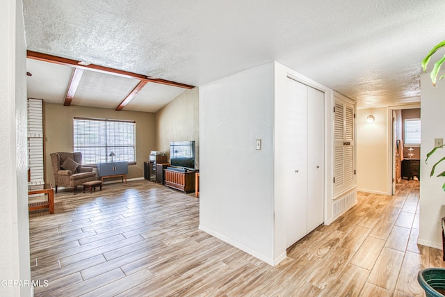 interior space with a textured ceiling and light wood-type flooring