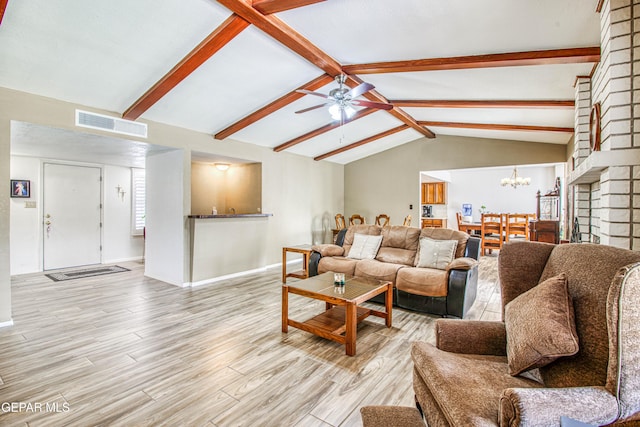 living room featuring visible vents, ceiling fan with notable chandelier, vaulted ceiling with beams, and light wood-style floors