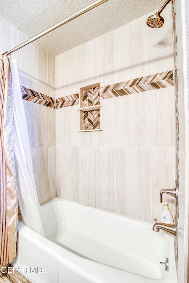 full bath featuring shower / bathtub combination with curtain and a textured ceiling