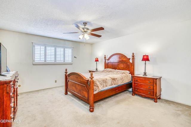 bedroom with baseboards, a textured ceiling, carpet, and a ceiling fan