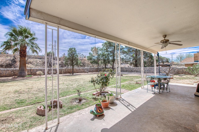 view of patio / terrace with glass enclosure and a ceiling fan