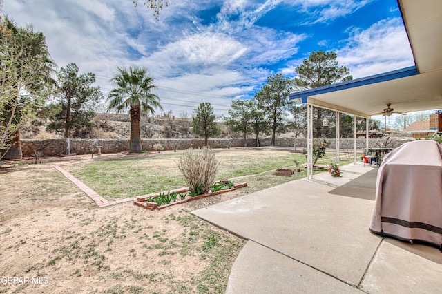 view of yard with a fenced backyard, ceiling fan, and a patio