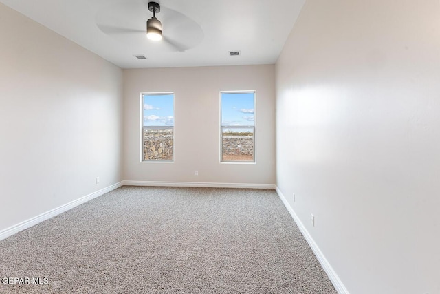 935 Bromyard Dr, Horizon City, TX 79928 - unfurnished room with visible vents, light colored carpet, baseboards, and ceiling fan