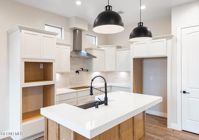 935 Bromyard Dr, Horizon City, TX 79928 - kitchen featuring tasteful backsplash, wall chimney exhaust hood, stovetop, and wood tiled floor