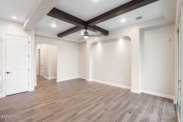 935 Bromyard Dr, Horizon City, TX 79928 - empty room featuring visible vents, wood finish floors, beam ceiling, arched walkways, and a ceiling fan