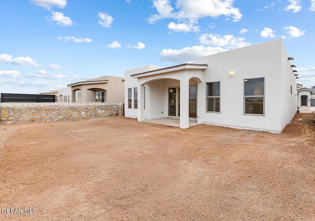 935 Bromyard Dr, Horizon City, TX 79928 - back of house with stucco siding and a patio