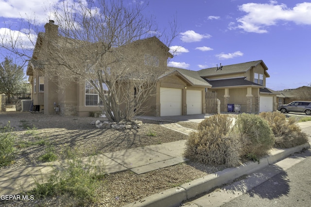 view of front facade featuring stucco siding, driveway, stone siding, a garage, and a chimney