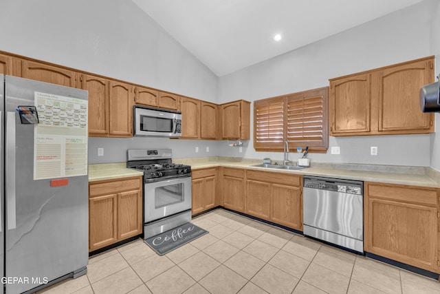 kitchen with light tile patterned floors, stainless steel appliances, light countertops, and a sink