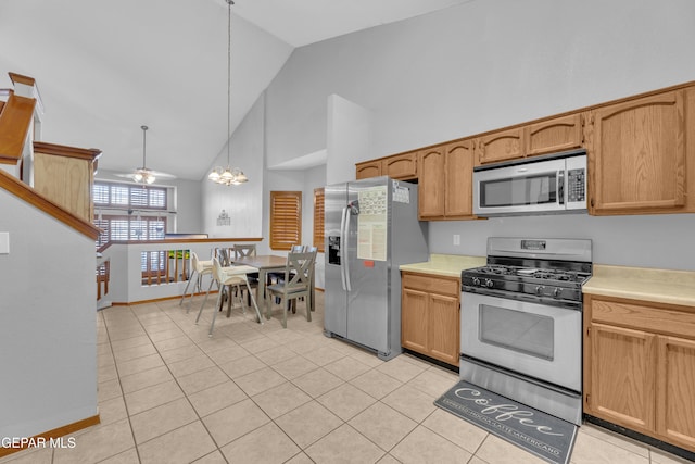 kitchen featuring a notable chandelier, appliances with stainless steel finishes, high vaulted ceiling, and light countertops