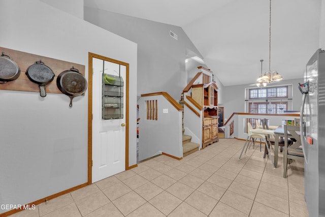 entryway featuring visible vents, a chandelier, stairs, lofted ceiling, and light tile patterned floors