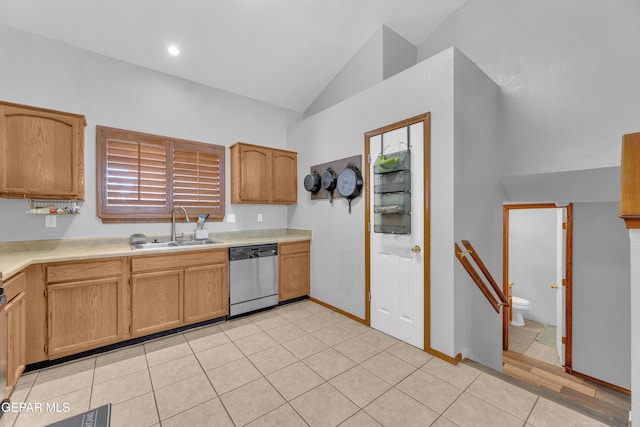 kitchen featuring light tile patterned floors, lofted ceiling, a sink, light countertops, and stainless steel dishwasher