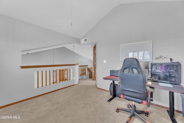 carpeted office with visible vents, baseboards, and high vaulted ceiling