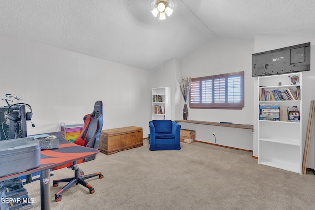 home office with baseboards, ceiling fan, carpet, vaulted ceiling, and a textured ceiling