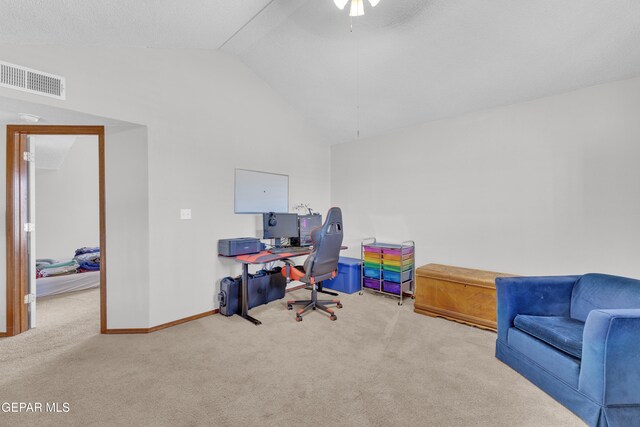 carpeted home office featuring visible vents, baseboards, lofted ceiling, and a ceiling fan