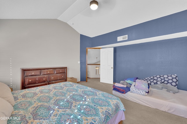 bedroom featuring visible vents, carpet floors, and vaulted ceiling