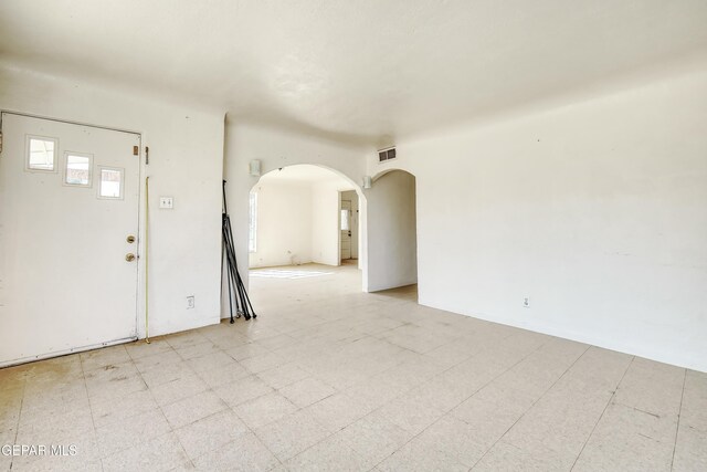 5930 Cleveland Ave, El Paso, TX 79905 - spare room featuring arched walkways, visible vents, and light floors