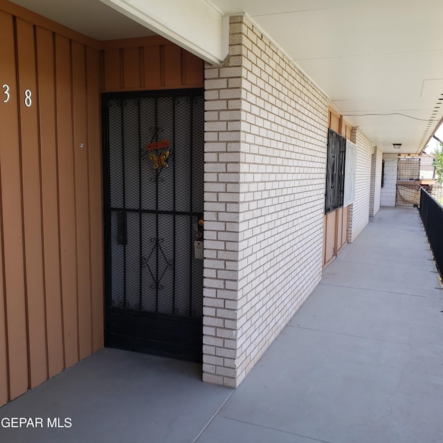 property entrance featuring brick siding