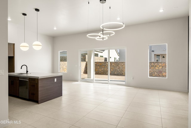 kitchen with open floor plan, dishwasher, light countertops, modern cabinets, and a sink